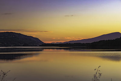 Scenic view of lake against romantic sky at sunset