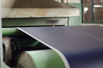 Close-up of exercise mat on conveyor belt in factory