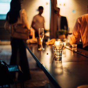 Group of people in glass on table