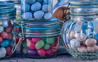 Glass jars filled with candy mini easter eggs and pink and green  jelly beans