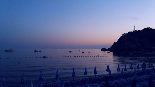 Scenic view of sea against clear sky at sunset