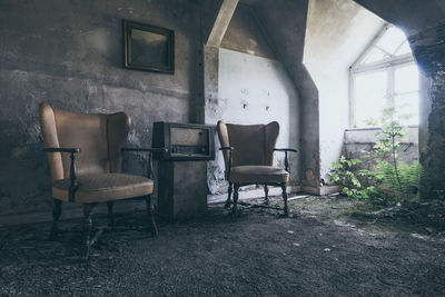 Empty chairs in abandoned building