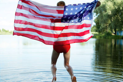 Rear view of woman standing in lake