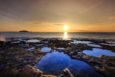 Scenic view of sea against sky during sunset