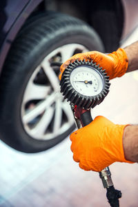 Close-up of mechanic holding pressure gauge