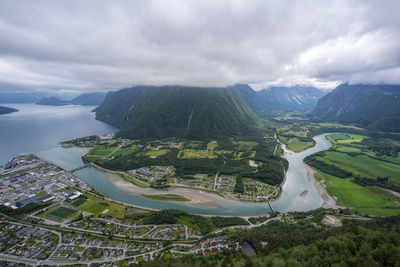 Aerial view of buildings and mountains against sky