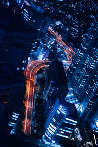 Low angle view of illuminated buildings in city at night