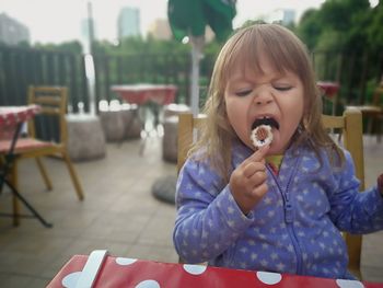 Girl eating food at restaurant