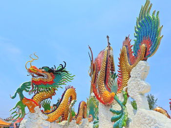 Low angle view of angel statue against clear sky