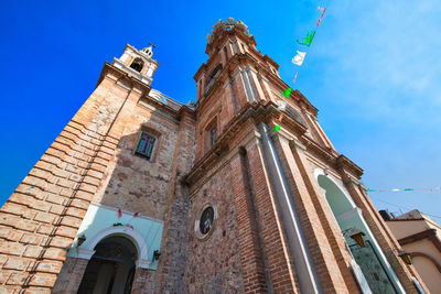 Low angle view of historic building against blue sky