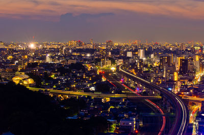 Downtown tokyo at dusk and train light trails