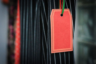Close-up of red label hanging on clothes