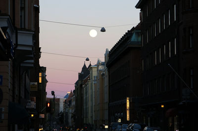 Low angle view of buildings in city at dusk