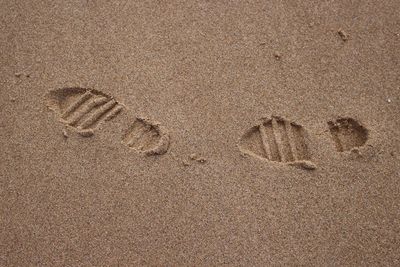 Full frame of shoe prints on sand