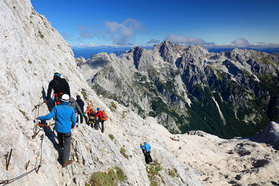 High angle view of hikers hiking on rocky mountain