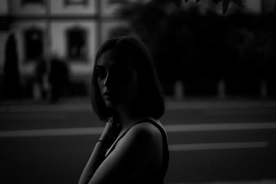 Portrait of woman standing on road