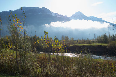 Scenic view of lake and mountains against sky