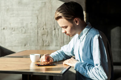 Man sitting on table at cafe