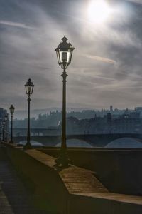 Street light in city against sky