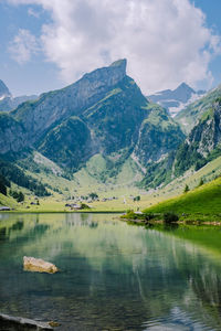 Scenic view of lake and mountains against sky