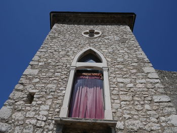 Low angle view of building against blue sky