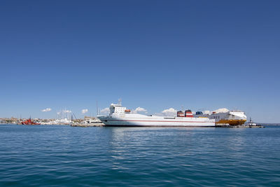 Ship in sea against clear blue sky