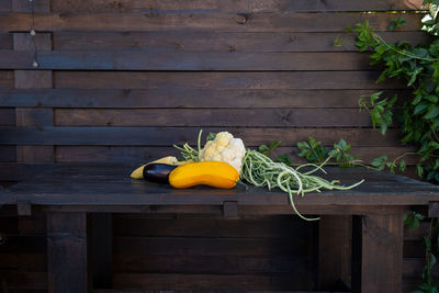 Organic farm vegetables on a dark wooden table. fresh raw cauliflower, green beans, zucchini, corn