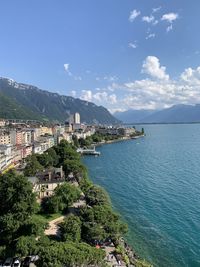 Scenic view of sea by buildings against sky