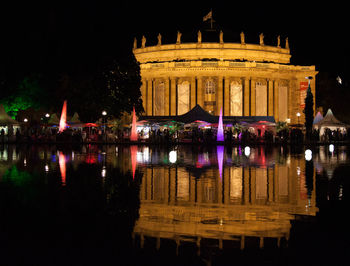Reflection of illuminated buildings in water