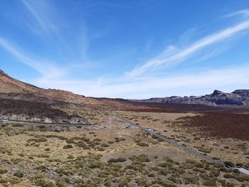 Scenic view of arid landscape against sky