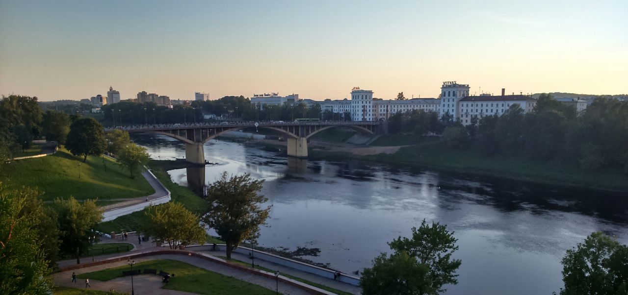 bridge - man made structure, architecture, connection, river, built structure, water, tree, arch bridge, building exterior, outdoors, sky, no people, bridge, sunset, cityscape, transportation, clear sky, city, nature, day