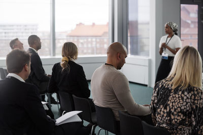 People listening at business meeting