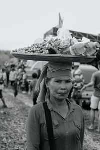 Rear view of man holding food at beach