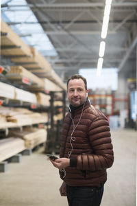 Male customer listens to musik in earphones at hardware store