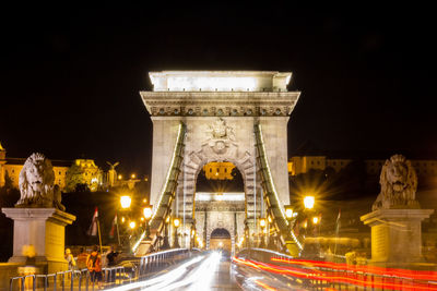 Statue of illuminated city at night