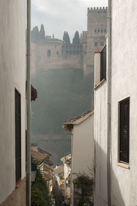 Buildings in town against sky