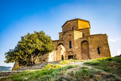 Low angle view of historical building against blue sky