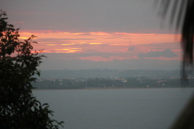 Scenic view of river against sky at sunset