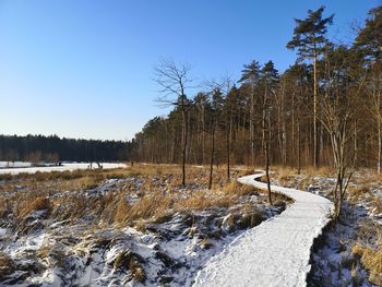 Scenic view of snow covered land against clear sky