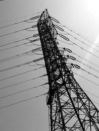 Low angle view of electricity pylon against sky