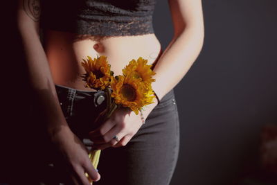 Midsection of woman holding flower bouquet