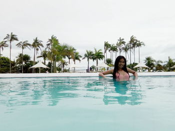 Portrait of young woman in swimming pool