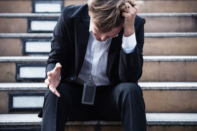 Worried man sitting on staircase