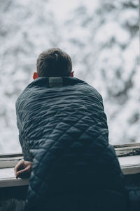 Rear view of man standing on snow