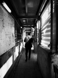 Rear view of people walking in corridor