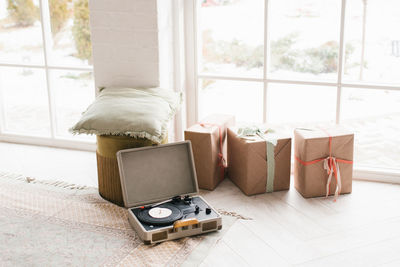 Vintage vinyl record player and gift boxes by the window in the house