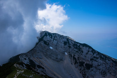 Clouds over the peaks of the alps on lake garda in the province of verona, italy