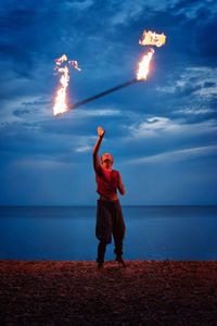 Man standing on beach against sky