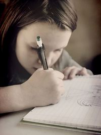 Close-up of a man with pen on paper