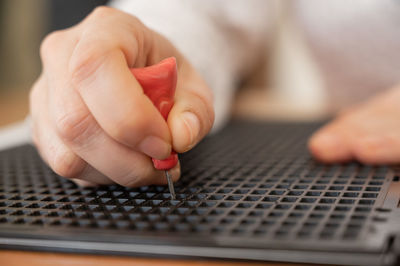 Cropped hand of man working on table